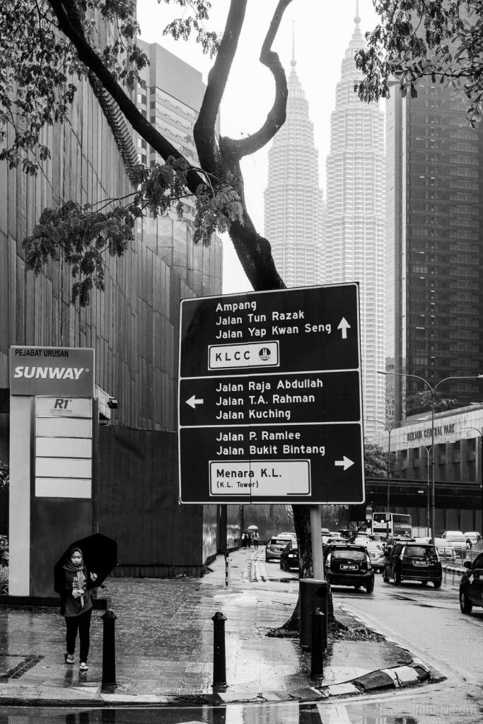 On a rainy day in Kuala Lumpur, the Petronas Twin Towers seen from Jalan Ampang road, not far from the Dang Wangi LRT station.