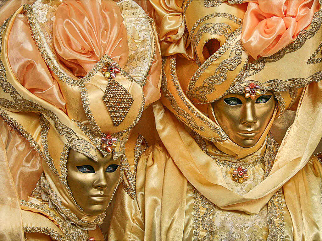 Couple dressed with yellow masks and costumes during Carnival of Venice